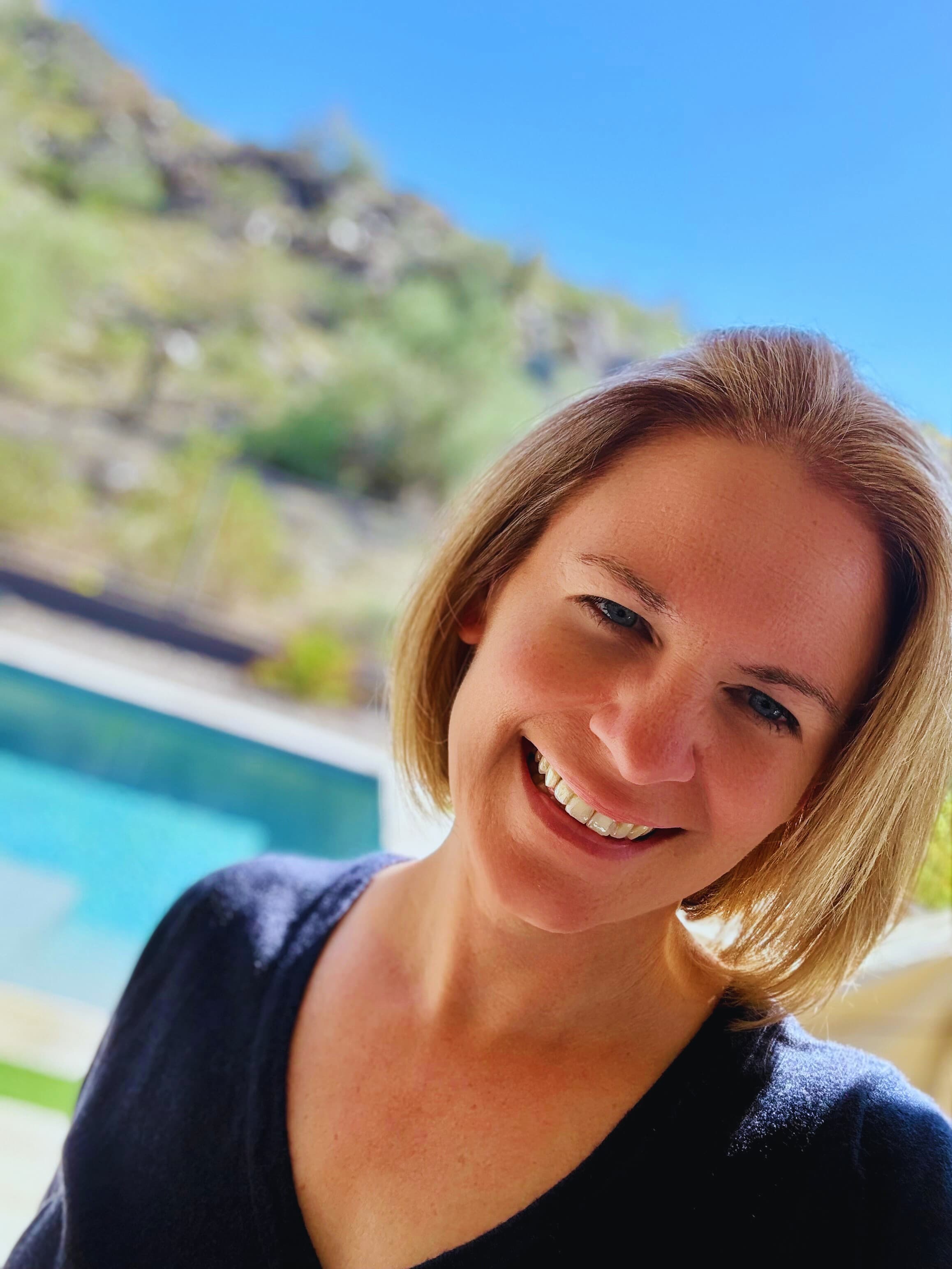 Tristin Oldani smiling outdoors by a pool